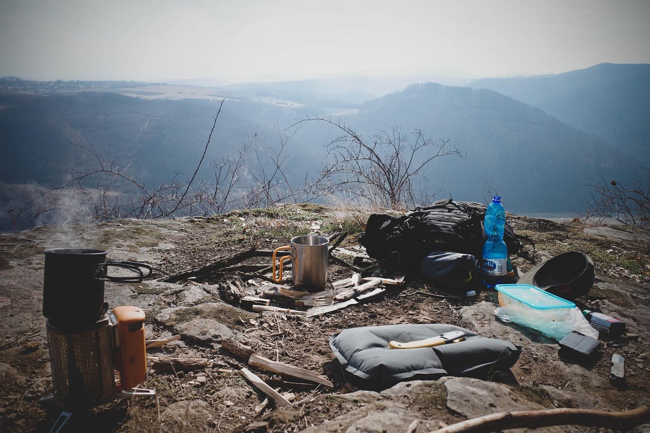 A well-prepared camp site with tents, lights, and gear staged for an emergency outing.